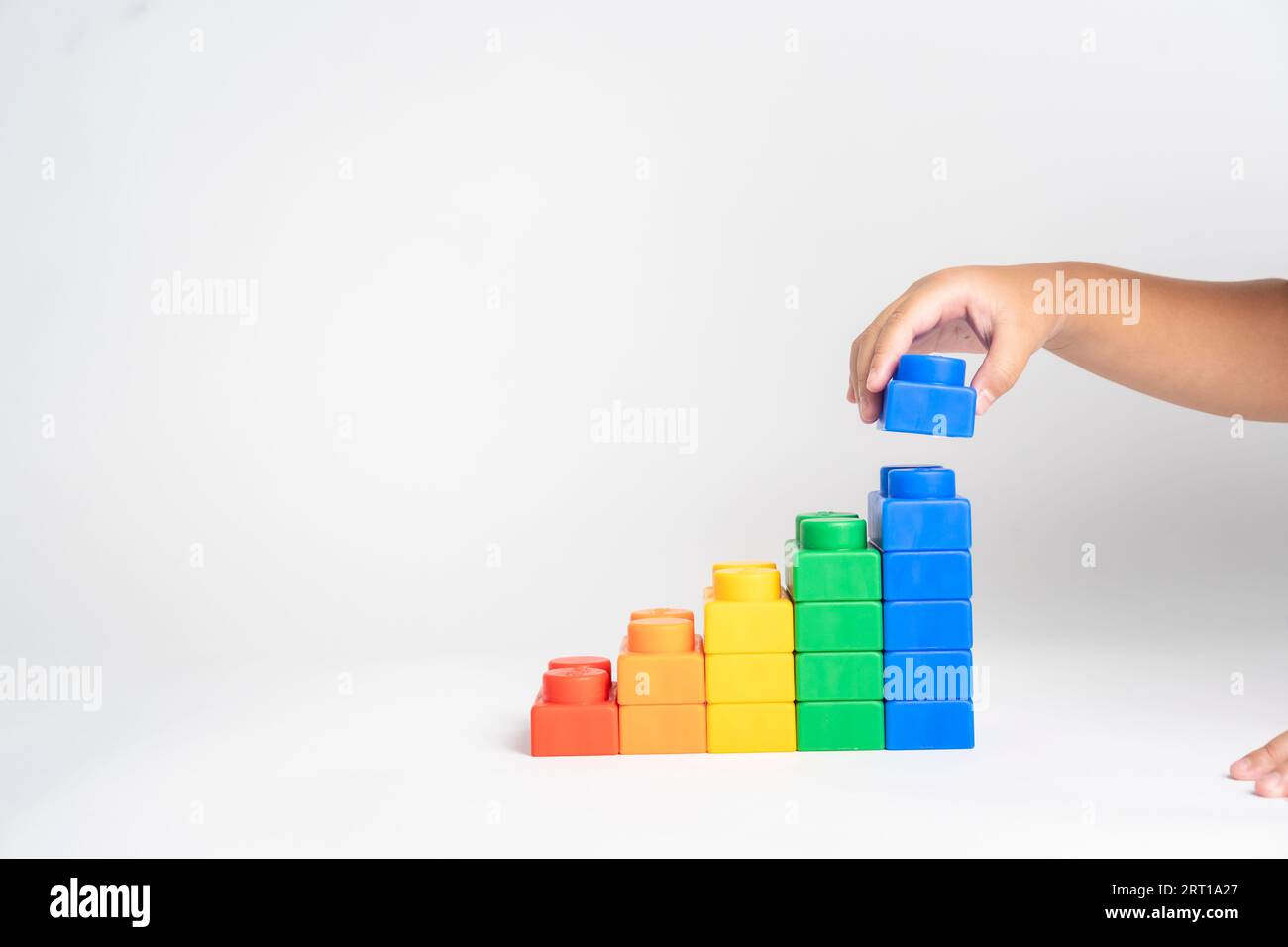 Kid hand put the colorful plastic building block toy Stock Photo - Alamy