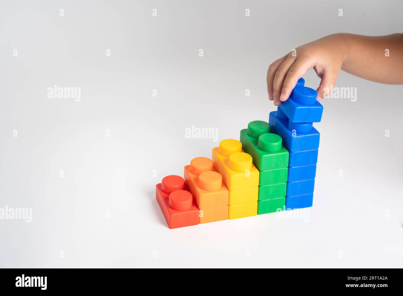 Kid hand put the colorful plastic building block toy Stock Photo - Alamy