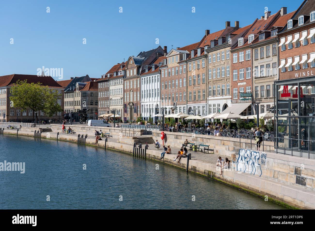 Copenhagen, Denmark, September 2, 2021: People enjoying a sunny day at Slotsholmen canal and Gammel Strand street Stock Photo