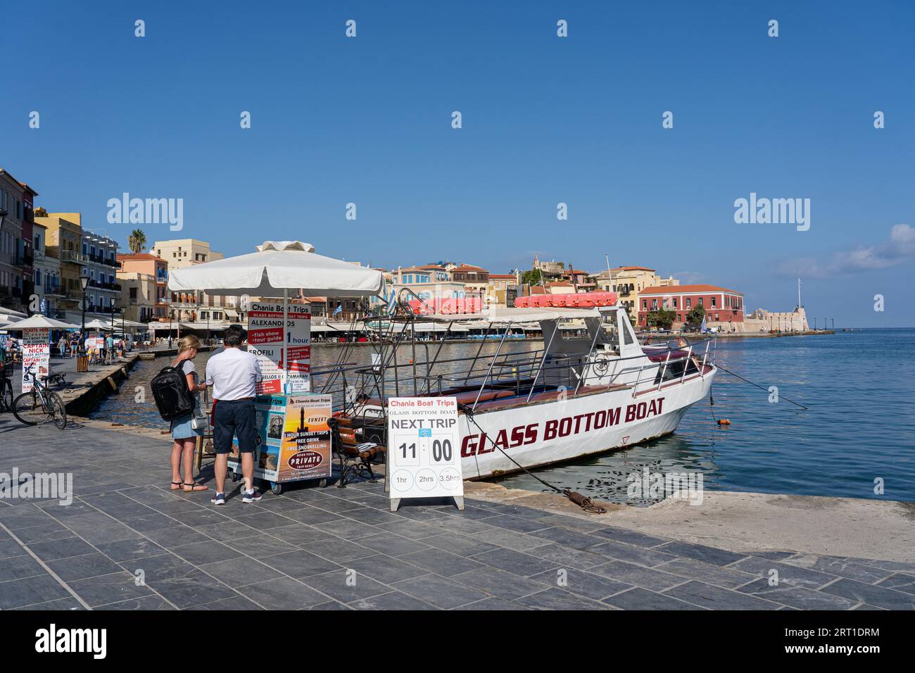 Chania, Greece, September 22, 2021: A glass bottom tour boat anchored in the old harbour Stock Photo