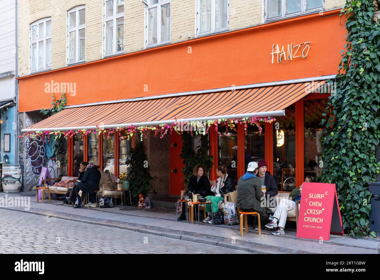 October 16, 2022, Copenhagen, Denmark: People sitting in a cafe on Vaernedamsvej in Vesterbro district Stock Photo