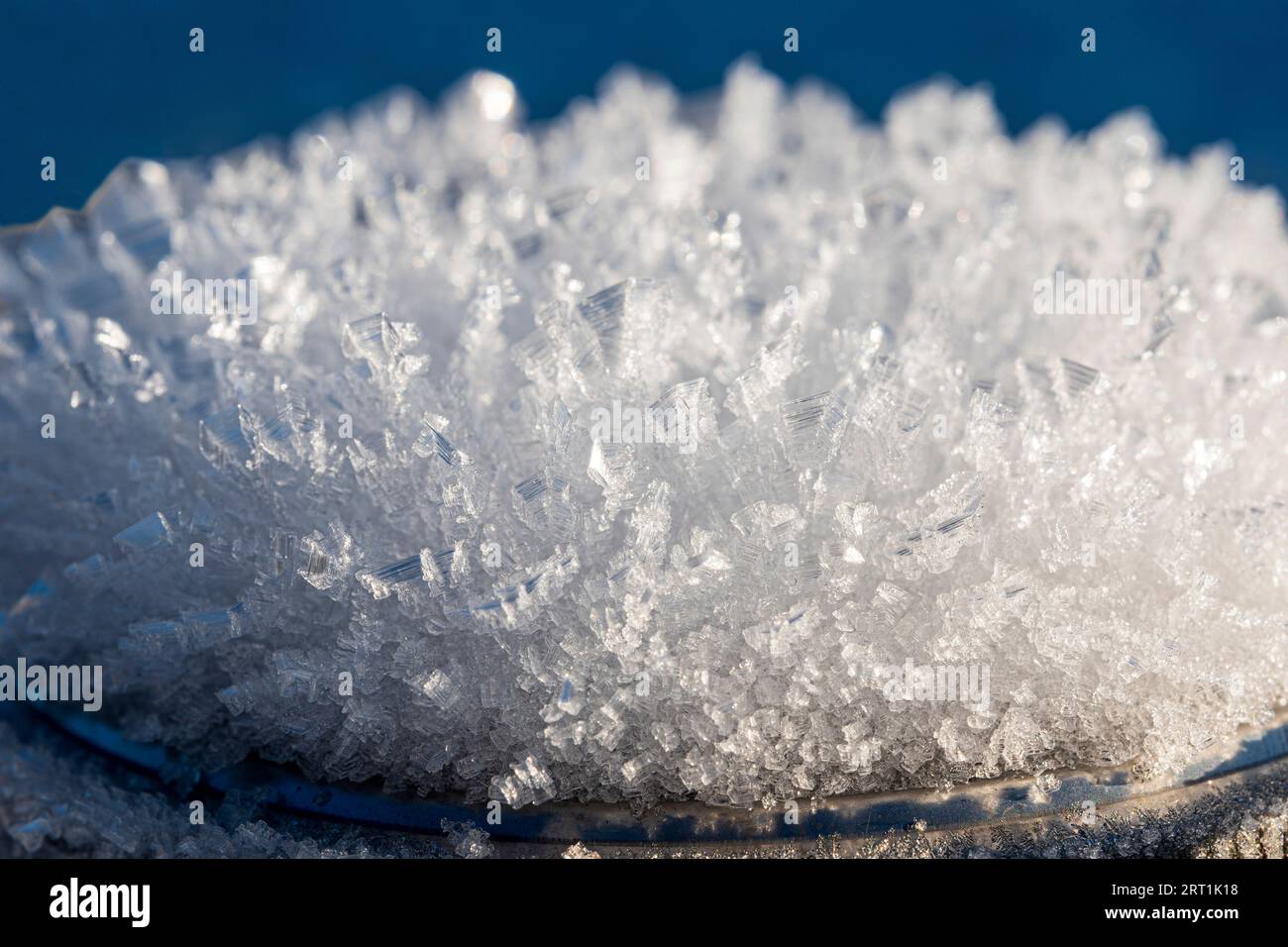 Macro shots of ice crystals against blue background Stock Photo - Alamy