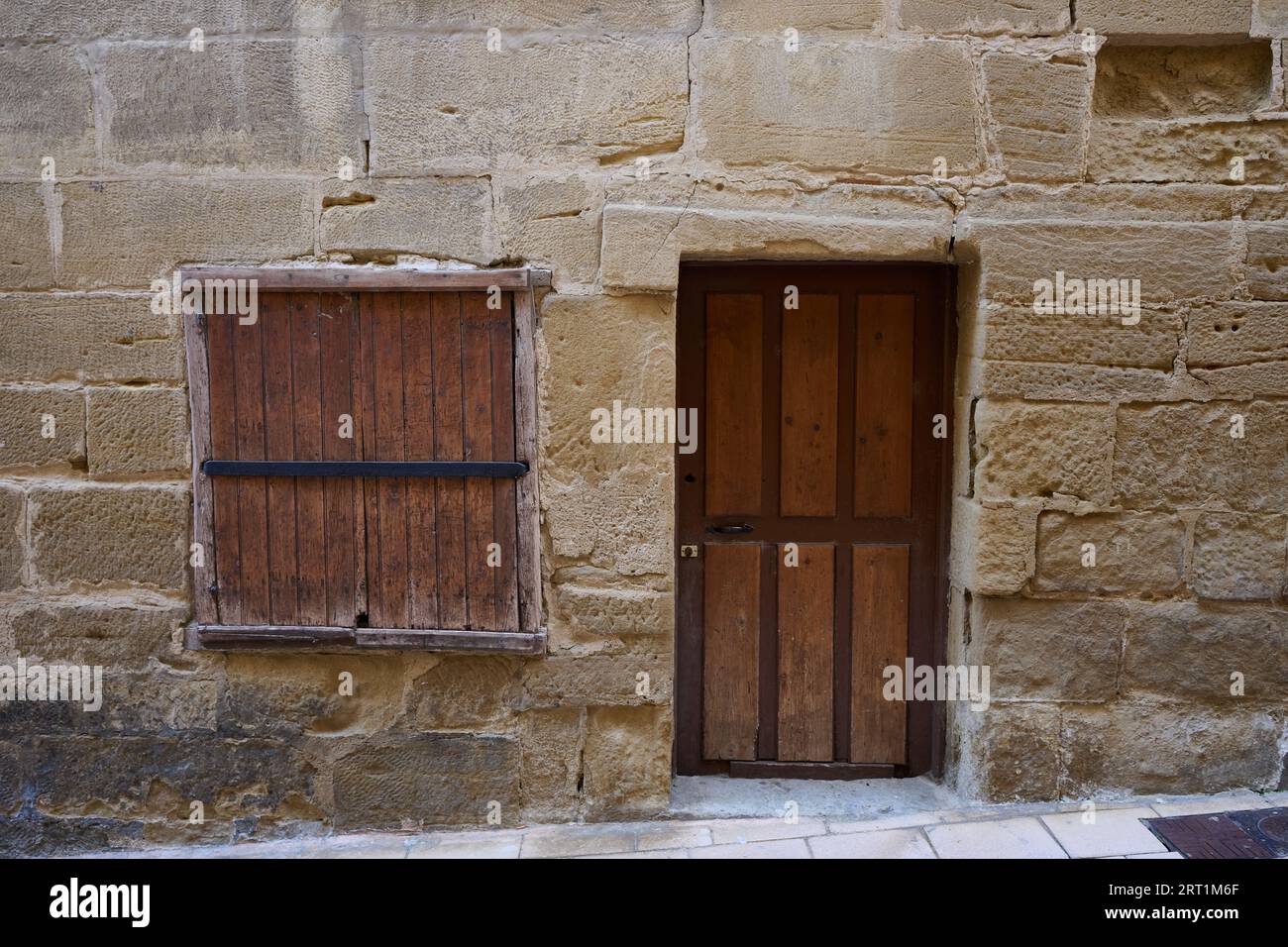 Ancient wooden door and window shutter in stone facade Stock Photo - Alamy