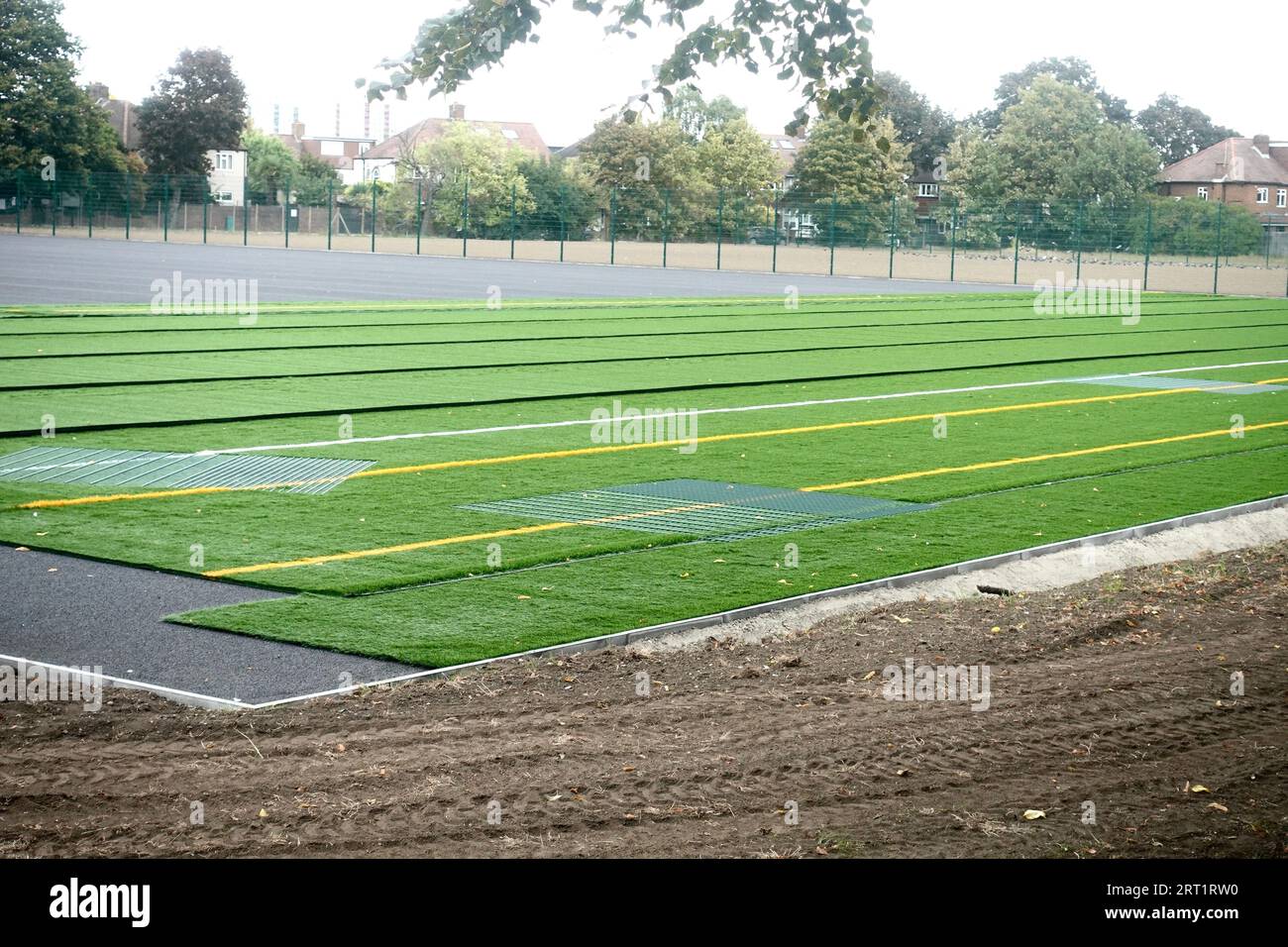 Astro Turf being laid over rugby & football fields in south west London
