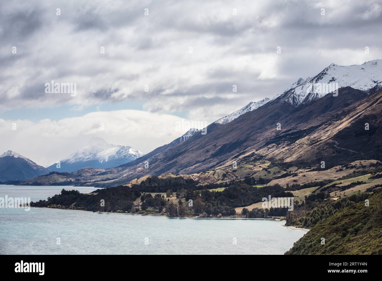 Lake Wakatipu and surrounding mountains, including Tooth Peaks from near Bennetts Bluff Lookout, on a sunny spring day approaching sunset near Stock Photo