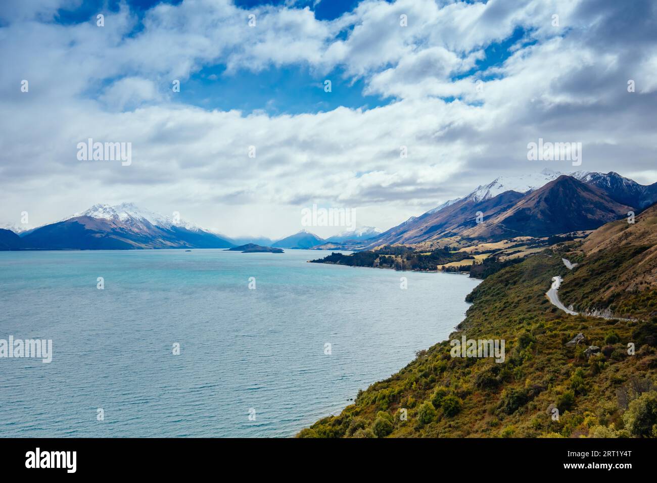 Lake Wakatipu and surrounding mountains, including Tooth Peaks from near Bennetts Bluff Lookout, on a sunny spring day approaching sunset near Stock Photo
