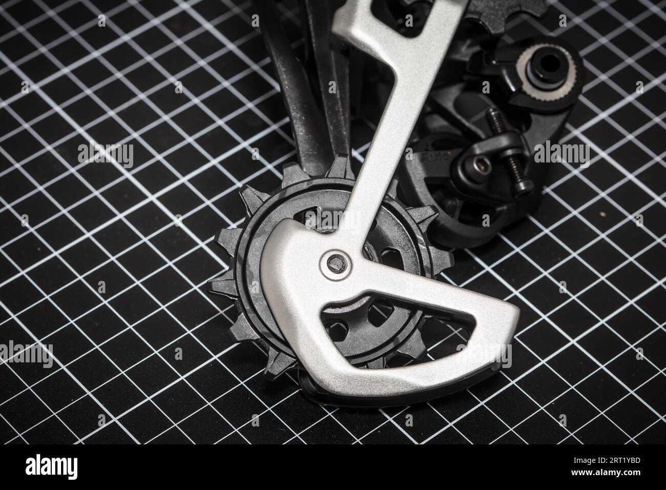 A bicycle rear derailleur ready to be installed onto a mountain bike