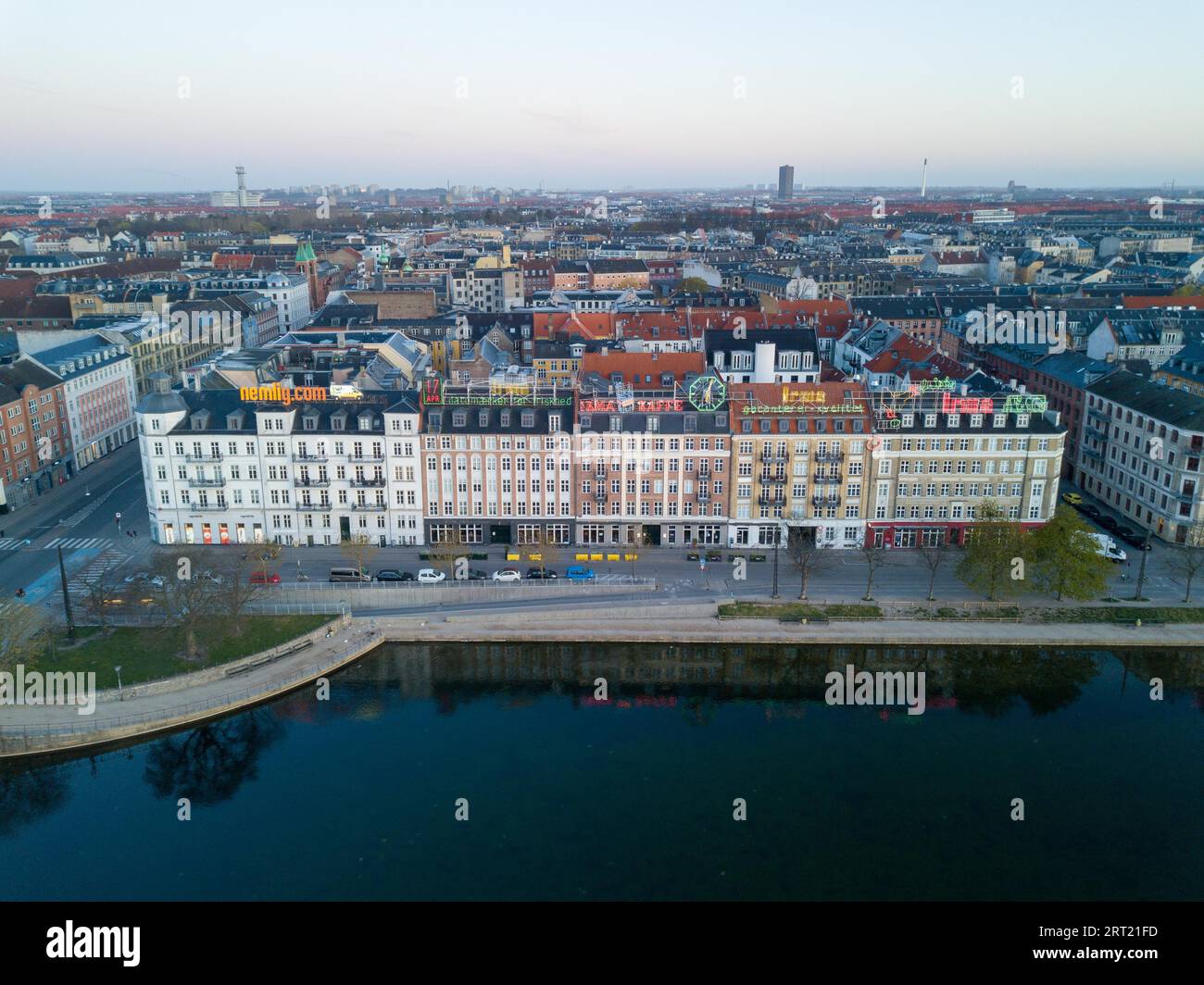 Copenhagen, Denmark, April 17, 2020: Aerial drone view of neon light advertisement billboards on buildings at night Stock Photo