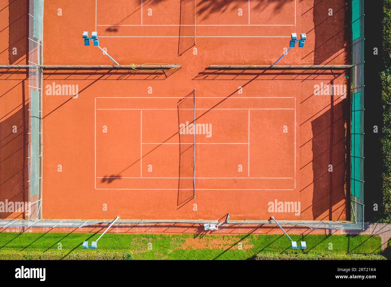 Aerial view of a single red clay tennis court without players Stock Photo