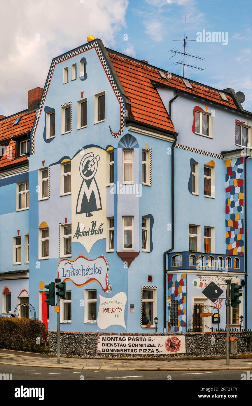 Germany, Cologne, Mature woman balancing on ladder during painting