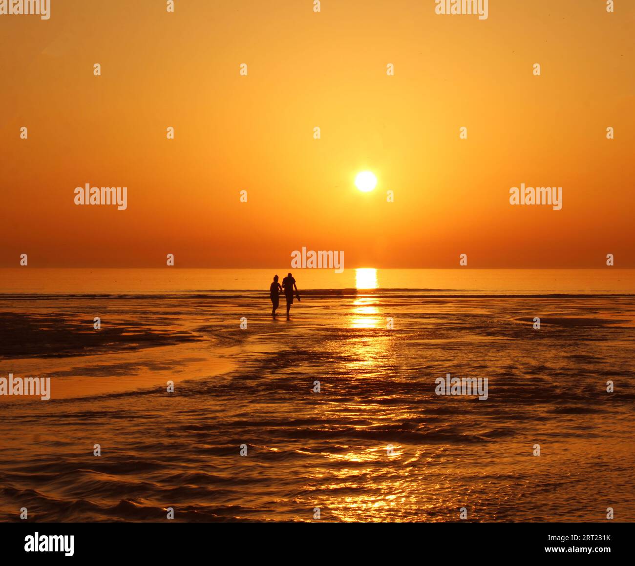 Romantic Sunset Beach Stroll Stock Photo