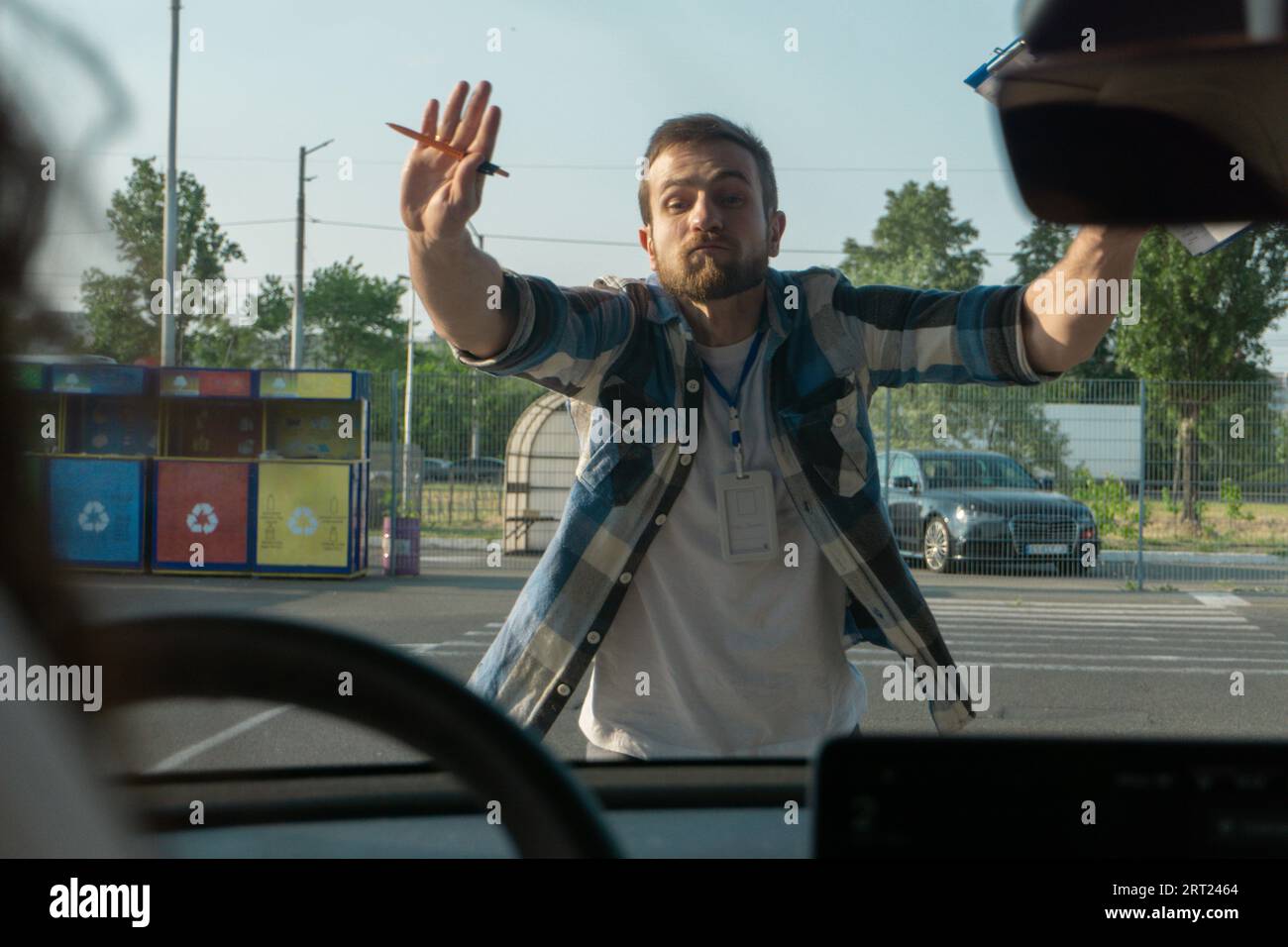 Stops Instructor Pin Male instructor showing stop with hands while teaching to park a car ...
