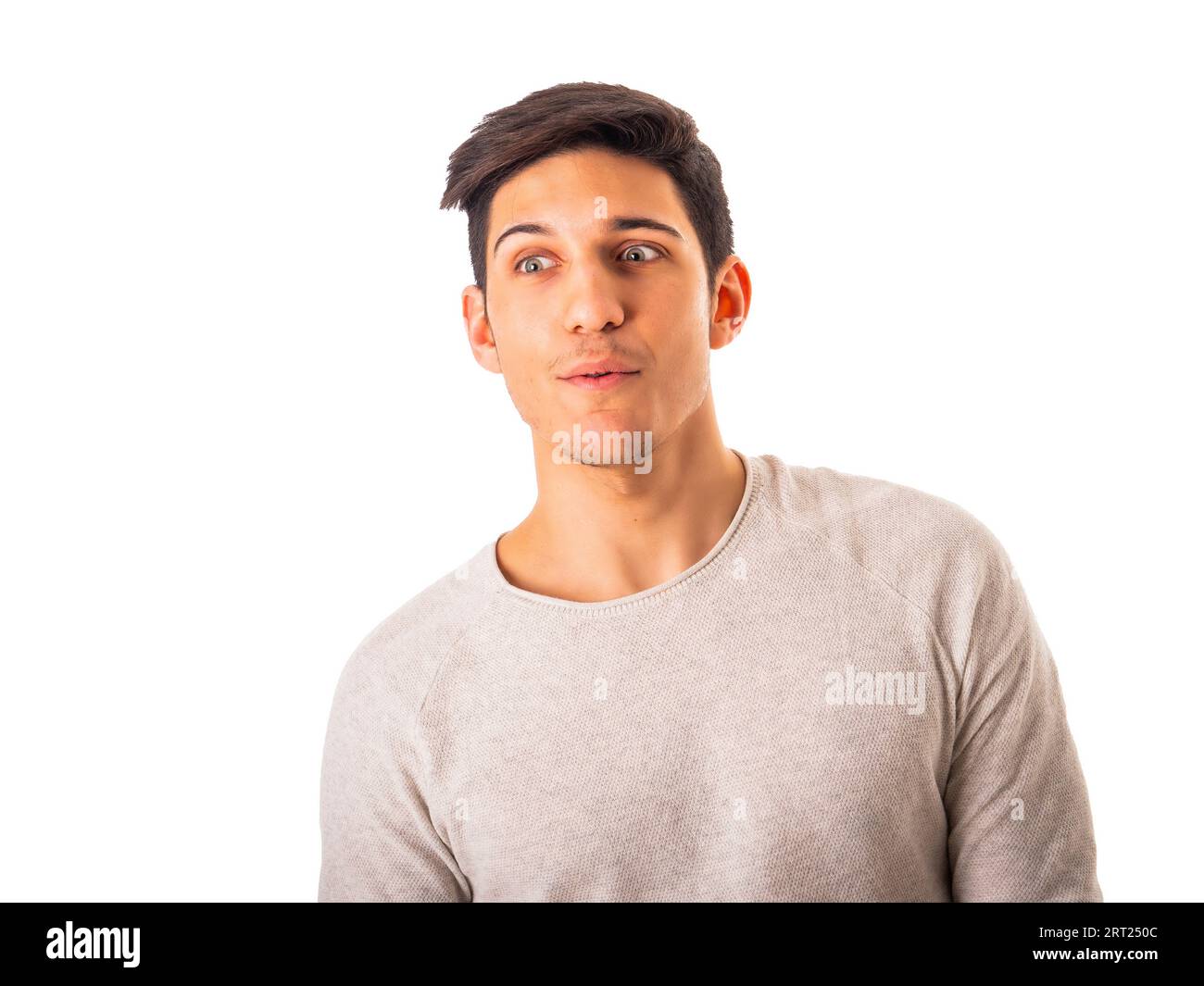 Young male with dark short hair and eyes wide open in gray sweatshirt looking away while being stunned by shocking news isolated on white background Stock Photo