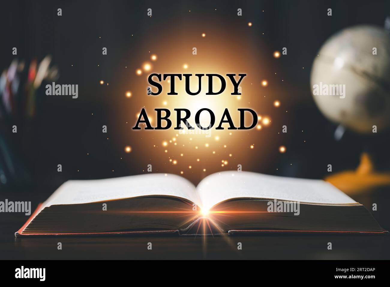 STUDY ABROAD inscription coming out from an open book, educational concept. Back to School. Education in Global world, Study abroad business in univer Stock Photo