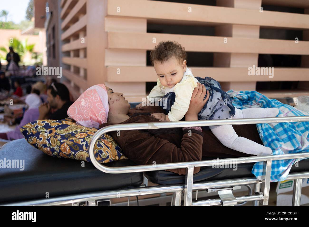 Marrakesh, Morocco. 10th Sep, 2023. A injured woman waits outside with her baby at the Hospital
