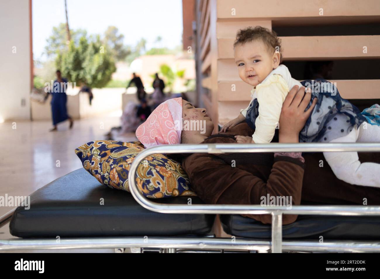 Marrakesh, Morocco. 10th Sep, 2023. A injured woman waits outside with her baby at the Hospital
