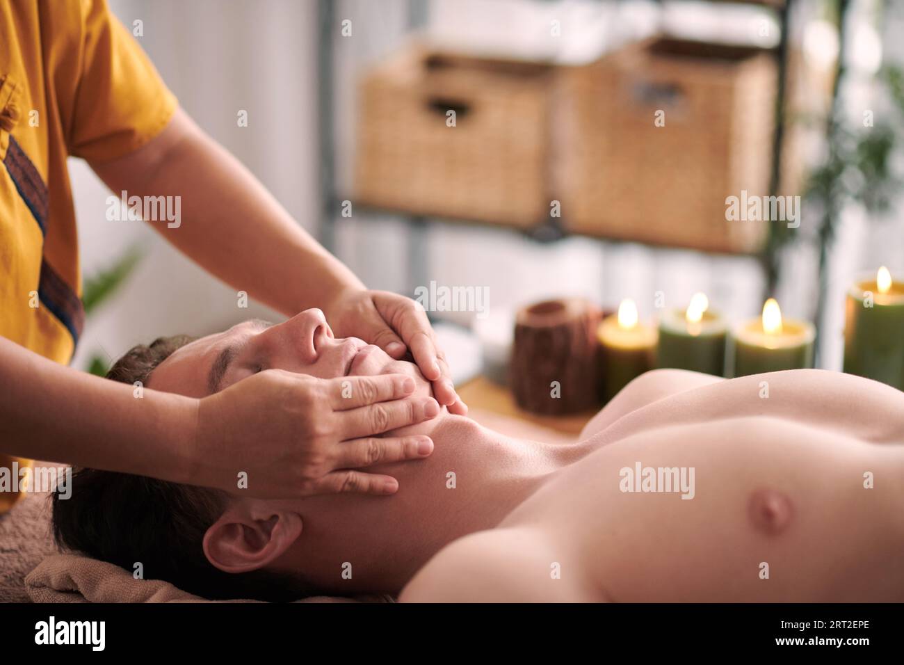 Beautician giving young man rejuvenating face massage to reduce appearance  of wrinkles and fine lines Stock Photo - Alamy