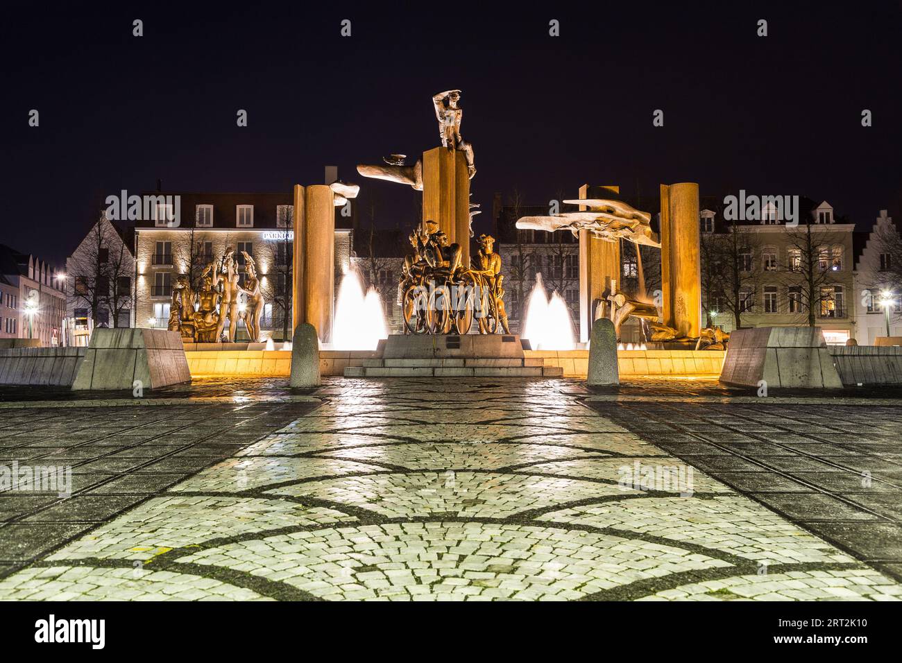 BRUGES, BELGIUM - 19th FEBRUARY 2016: A view towards a water fountain and statue at Het Zand square at night in Bruges. Stock Photo