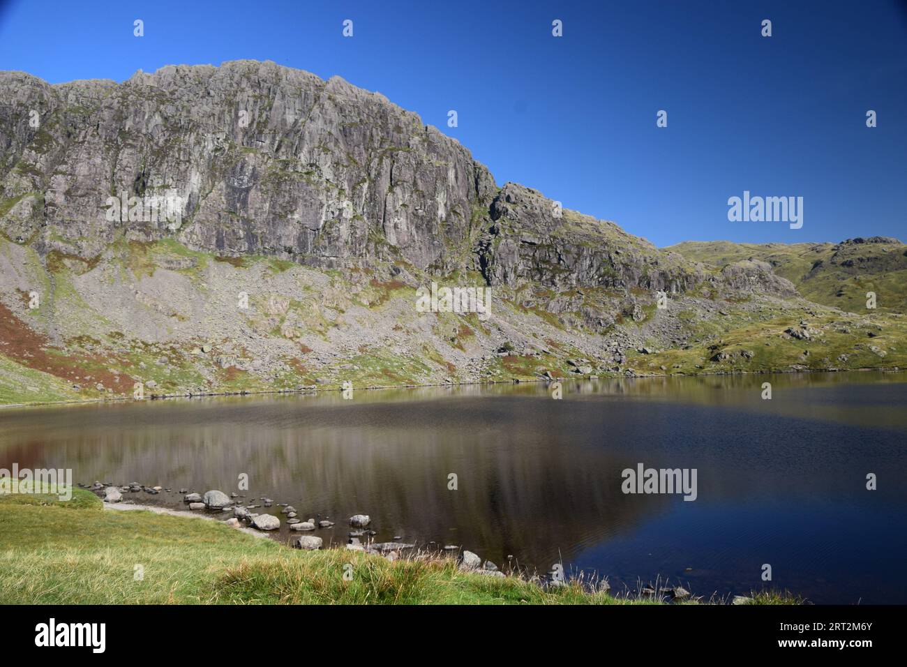 Stickle tarn a beautiful glacial tarn high up in the Langdales of the Lake District. Stock Photo
