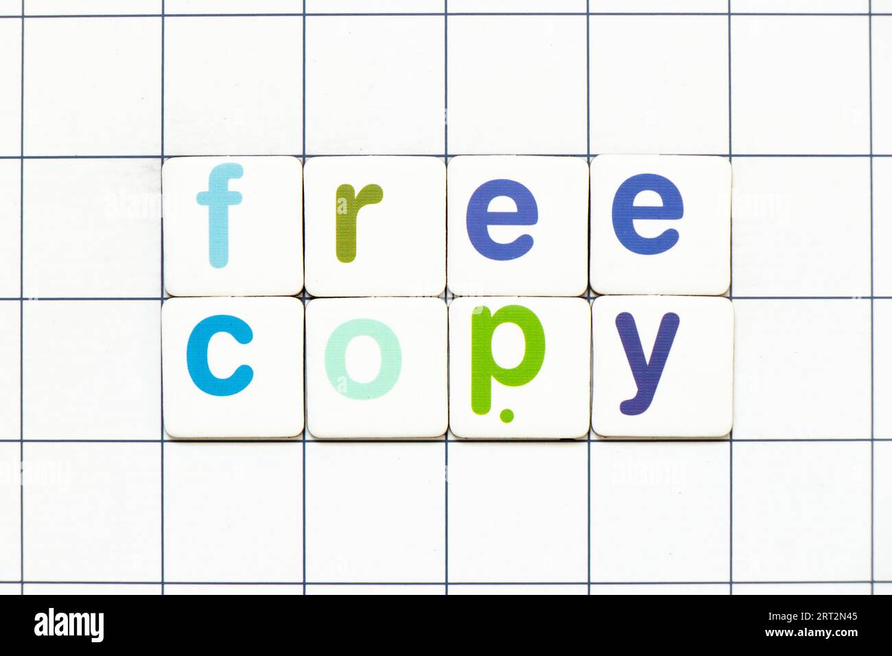 Colorful tile letter in word free copy on white grid background Stock Photo