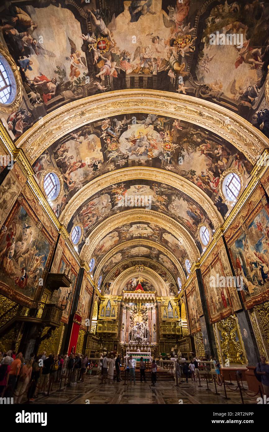 Valletta, Malta - 17 June 2023: Frescoed nave with altar in background in Valletta Cathedral, Malta Stock Photo