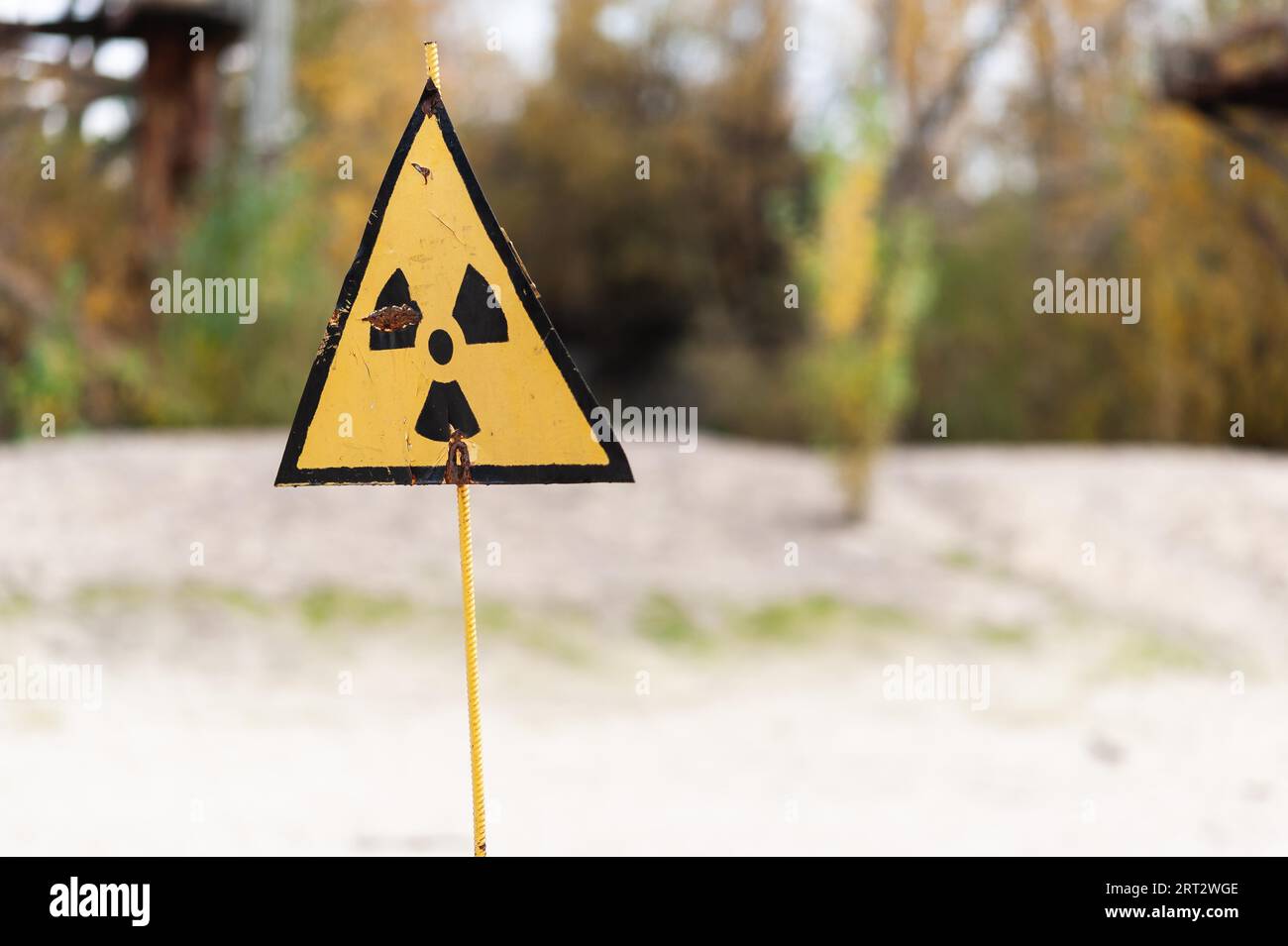 Yellow radioactive warning sign on metal rod in Chernobyl Exclusion