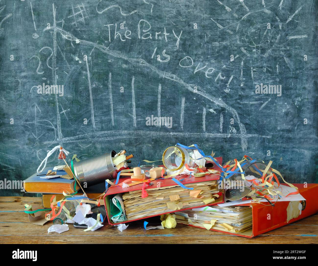 business concept,economic crisis,recession,inflation,poverty and economic inequality.Messy office desk,blackboard with declining stocks and slogan the Stock Photo