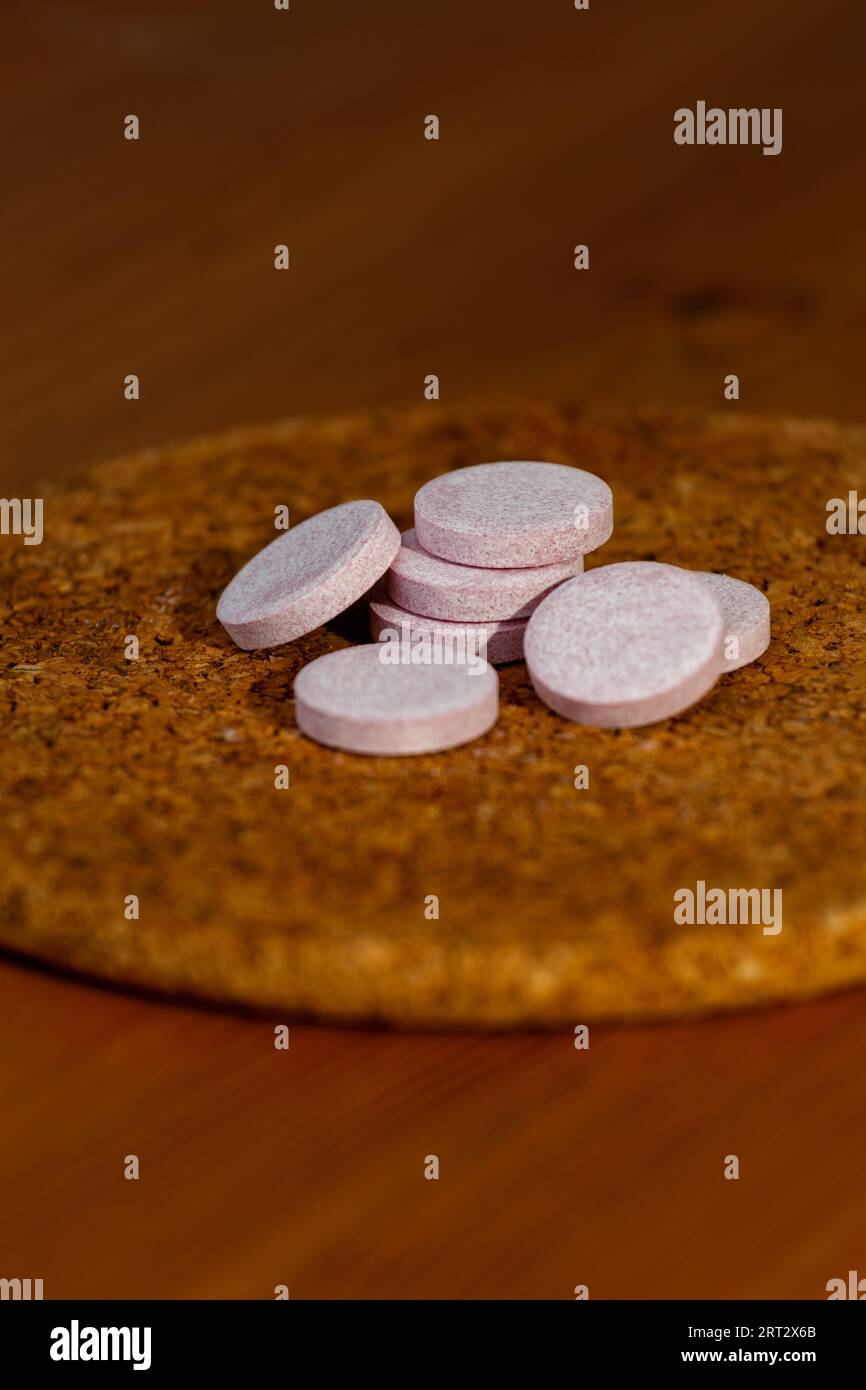 Several vitamins are placed on a cork circle. Stock Photo