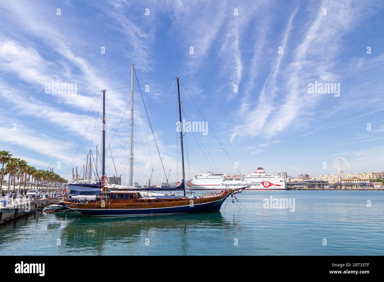Malaga, Spain, May 24, 2019: A sailboat anchored in the harbour at the new Muello Uno district Stock Photo