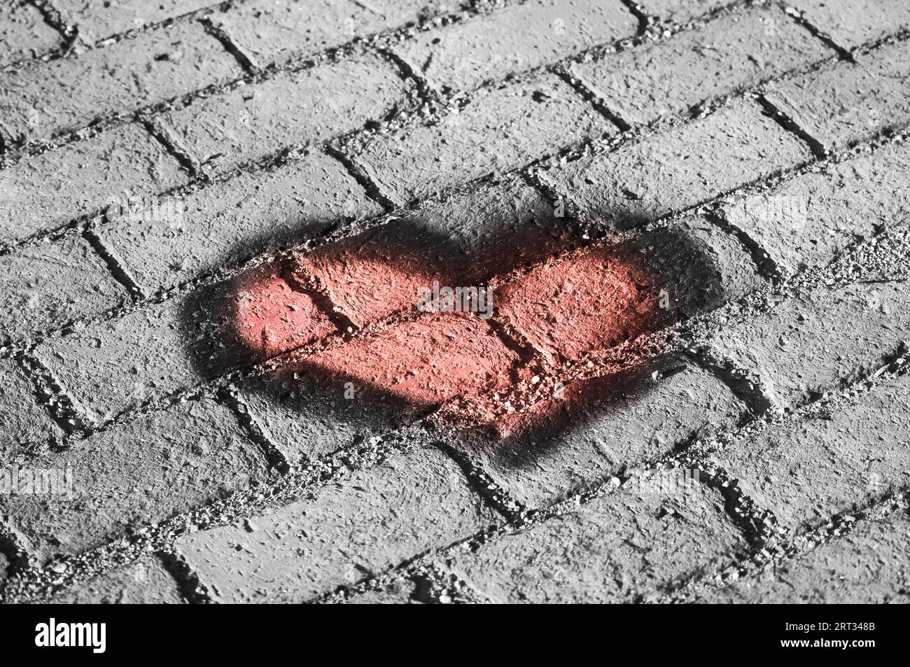A heart on a background of bricks. Heart texture Stock Photo