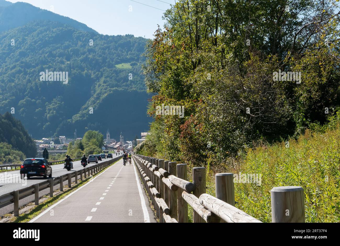 Pontebba, Italy (9th Septermber 2023) - The entrance to the alpine town of Pontebba with the highway and the Alpe Adria bike trail Stock Photo