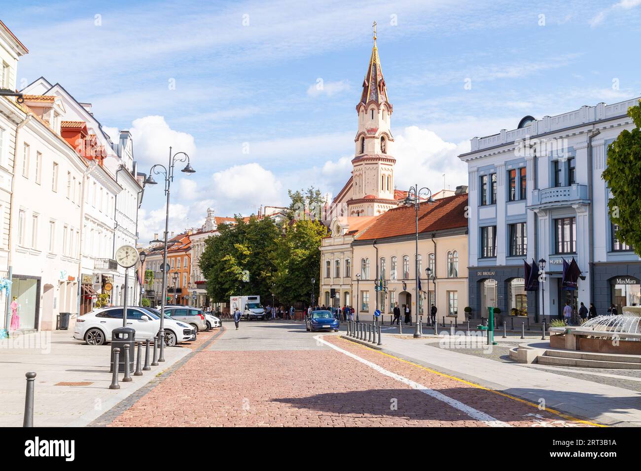 VILNIUS, LITHUANIA - 1ST SEPT 2023: Streets in Vilnius Old Town. Showing architecture and a church tower. People can be seen outside. Stock Photo