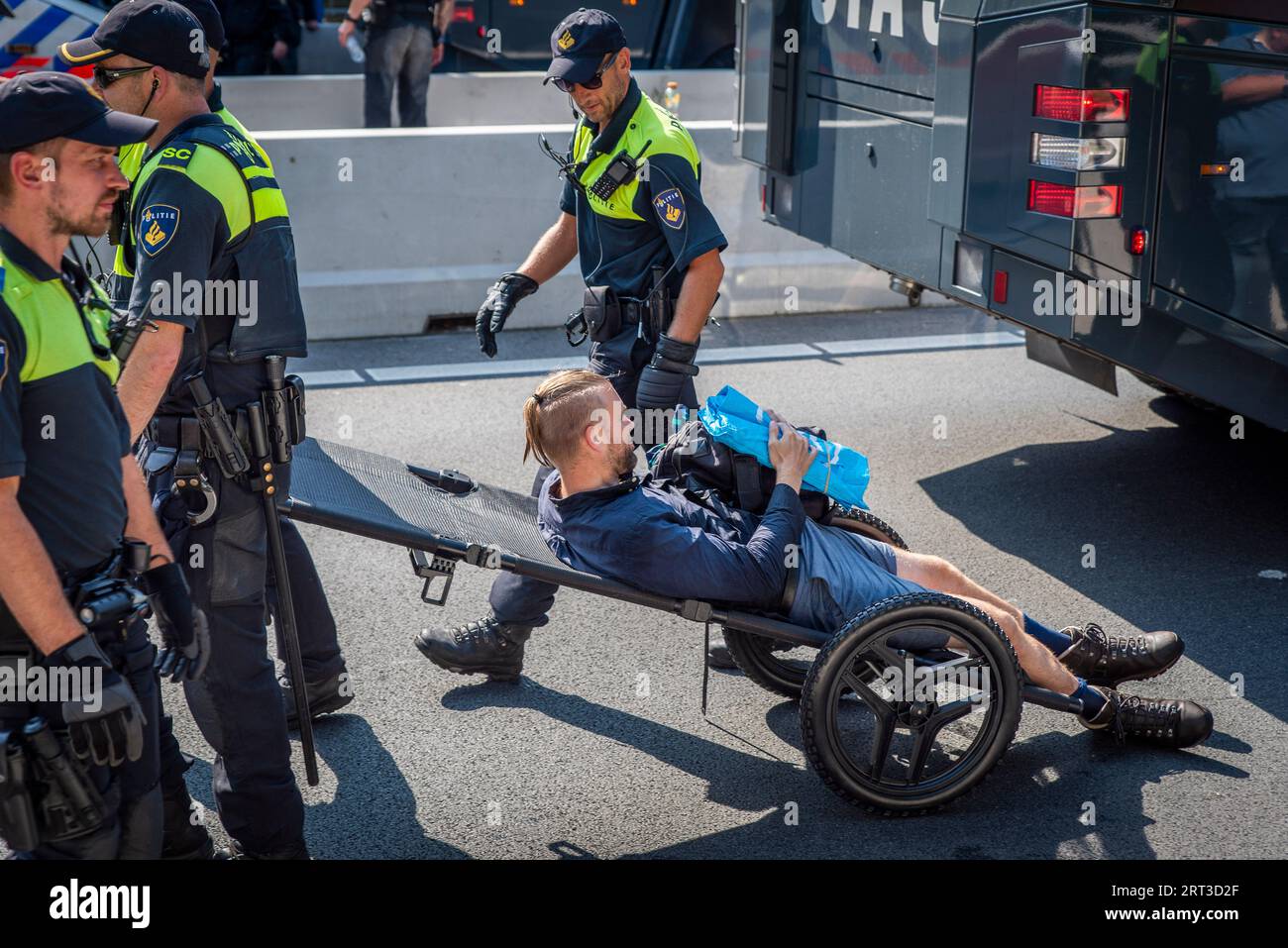 The Hague, South Holland, Netherlands. 9th Sep, 2023. Dutch police use repurposed stretchers to move arrested climate activists. On 9 September, 2023, Extinction Rebellion activists blocked the A12 Highway running through the center of The Hague, The Netherlands. The protest was in opposition to the Dutch government's billions of euros in subsidies to the fossil fuel industry. (Credit Image: © James Petermeier/ZUMA Press Wire) EDITORIAL USAGE ONLY! Not for Commercial USAGE! Stock Photo