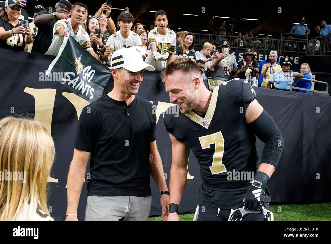 Former New Orleans Saints quarterback Drew Brees, left, talks with