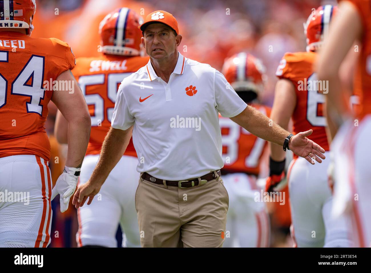 Clemson head coach Dabo Swinney greets players as the run onto the ...