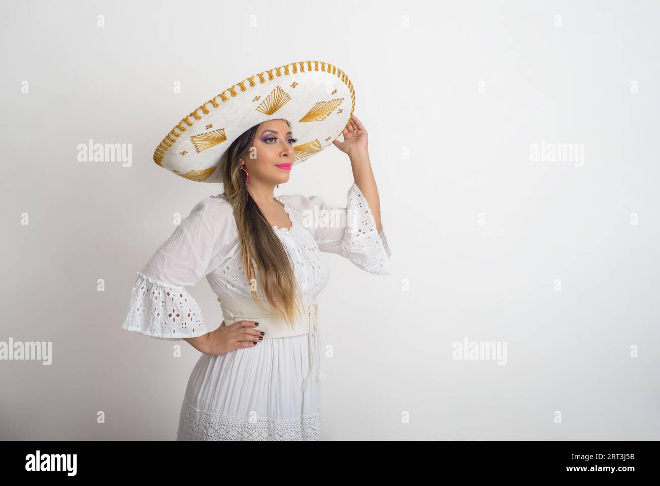 Mexican woman wearing a mariachi hat. Woman with sombrero, white