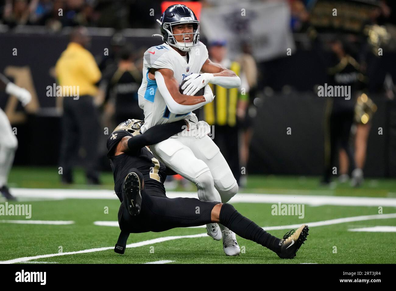 New Orleans Saints cornerback Alontae Taylor, left, tackles Tennessee  Titans wide receiver Nick Westbrook-Ikhine, right, after a catch in the  first half of an NFL football game in New Orleans, Sunday, Sept.