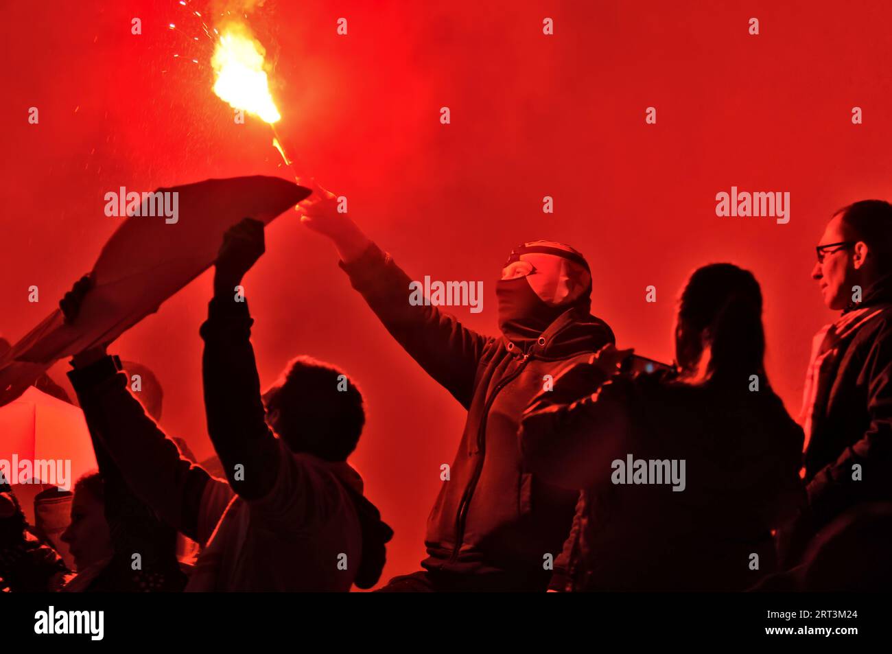Footbal soccer match Slavia Praha - Zbrojovka Brno. Slavia hooligans fans with smoke bombs and flags support their team.  Eden stadium. Stock Photo