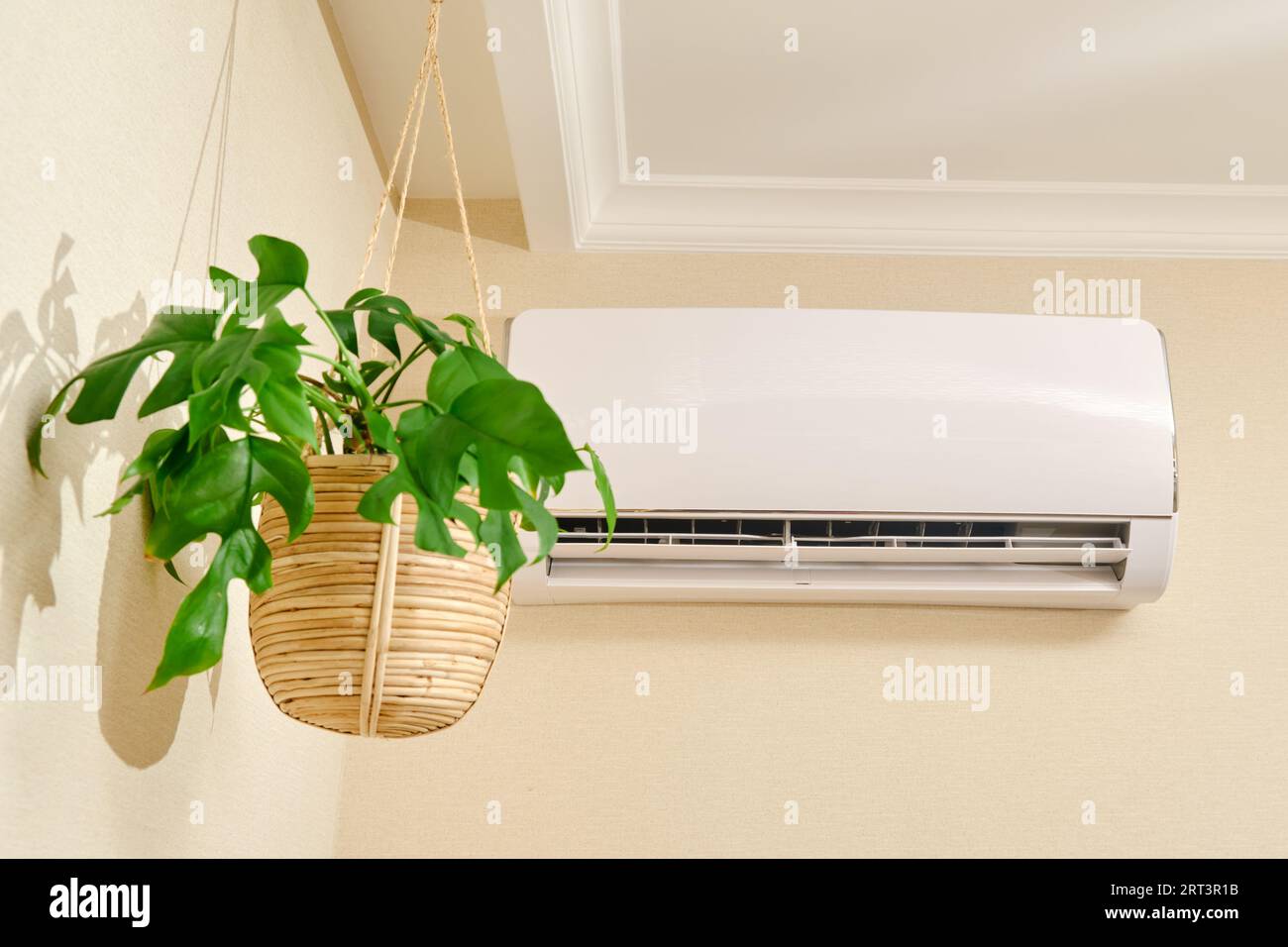 The white air conditioner controls the temperature in the living room