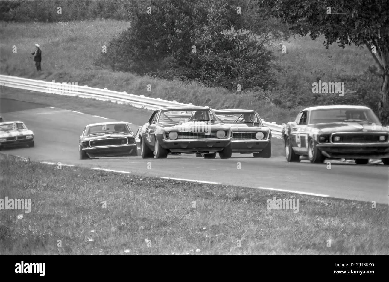 Cars coming uphill though turn 3 at the 1969 Trans Am at Watkins Glen