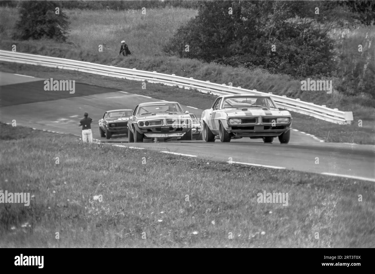 Cars coming uphill though turn 3 at the 1969 trans am at watkins glen