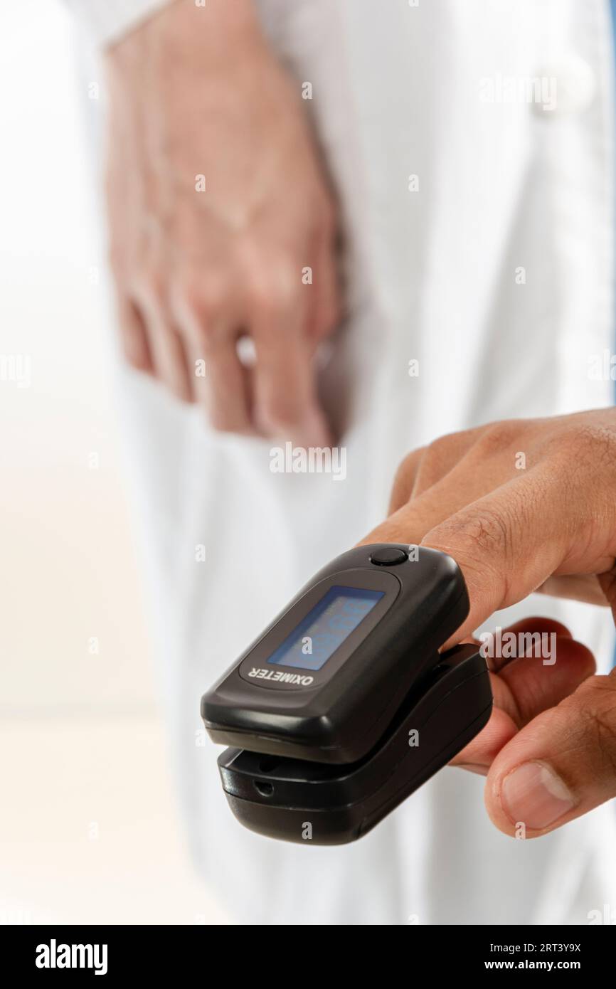 Finger of an Asian Adult from India using a pulse oximeter in the