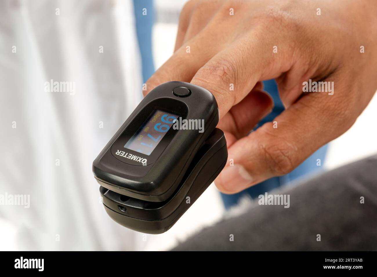 Finger of an Asian Adult from India using a pulse oximeter in the