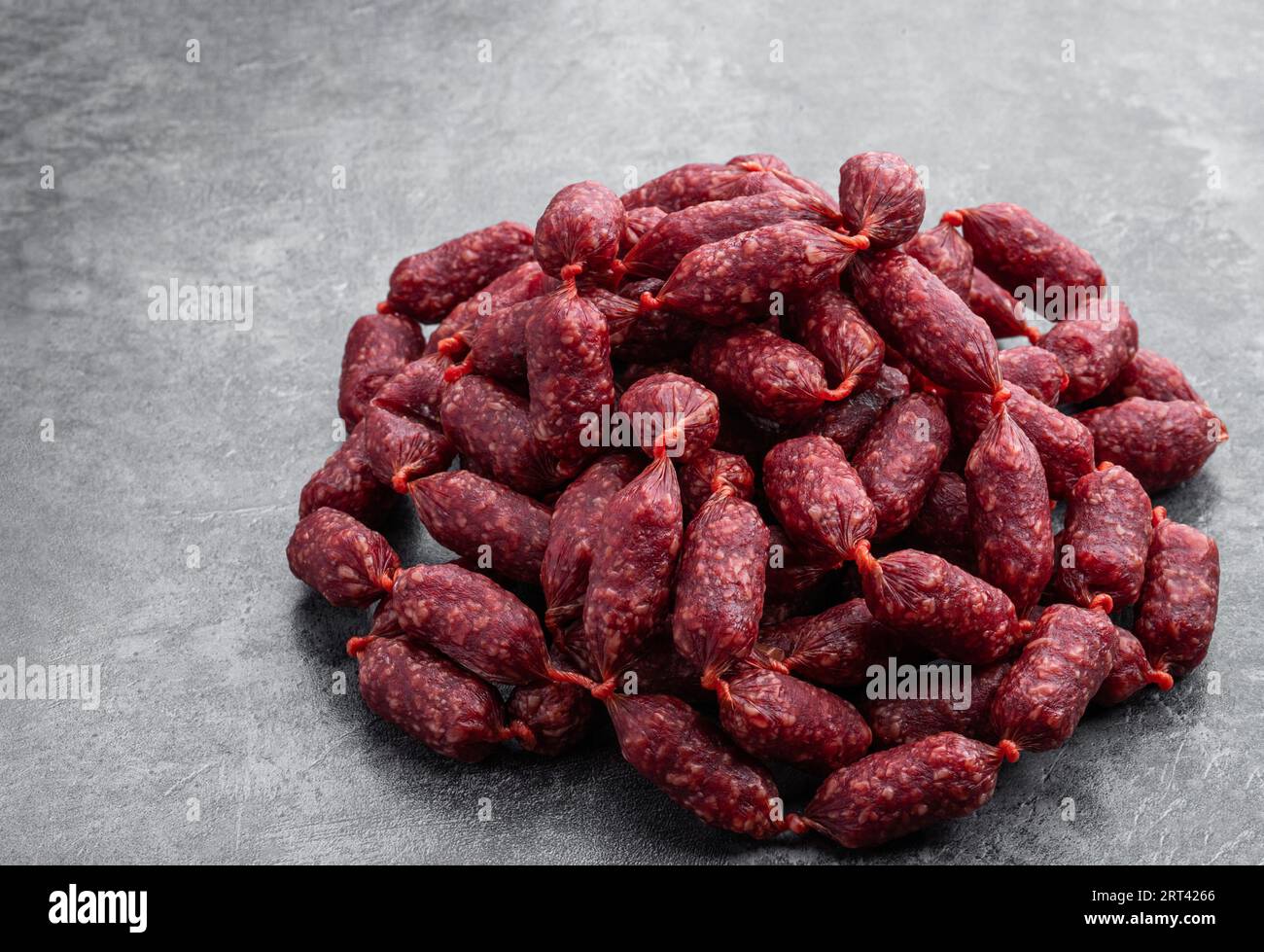Mini  salami sausages on gray background Stock Photo