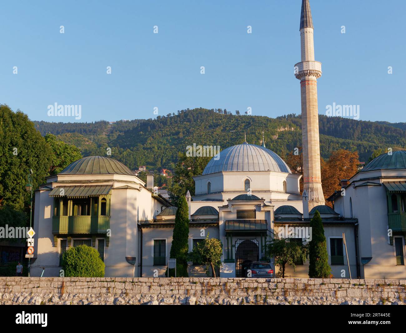 Emperor's Mosque with lush hills and blue sky behind on a summers evening in the city of Sarajevo, Bosnia and Herzegovina, September 10, 2023 Stock Photo