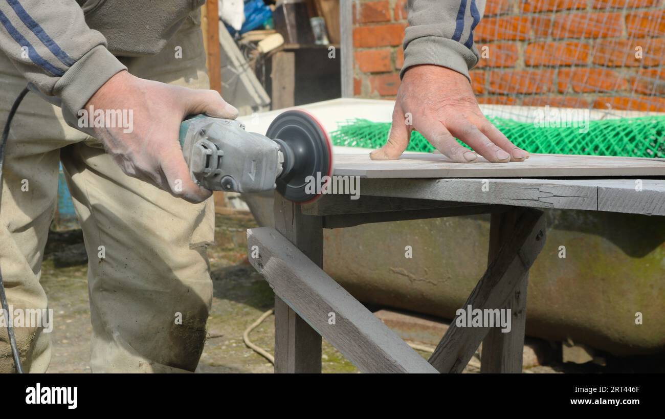 grinding the edge of a stone tile with a miter saw an emery