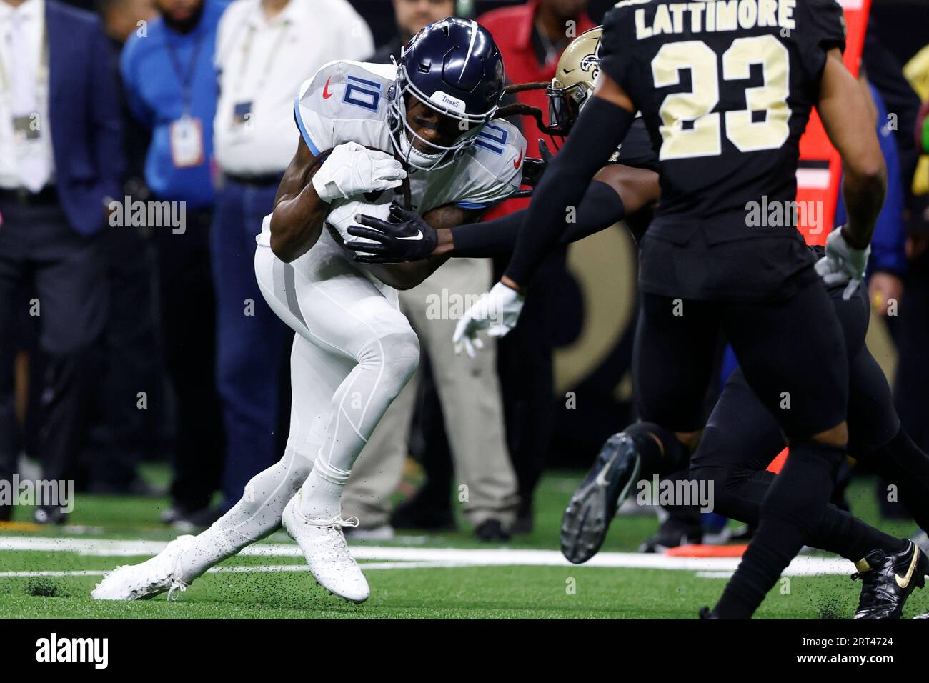 Tennessee Titans wide receiver DeAndre Hopkins (10) is stopped after a  catch by a New Orleans Saints defender in the first half of an NFL football  game in New Orleans, Sunday, Sept.