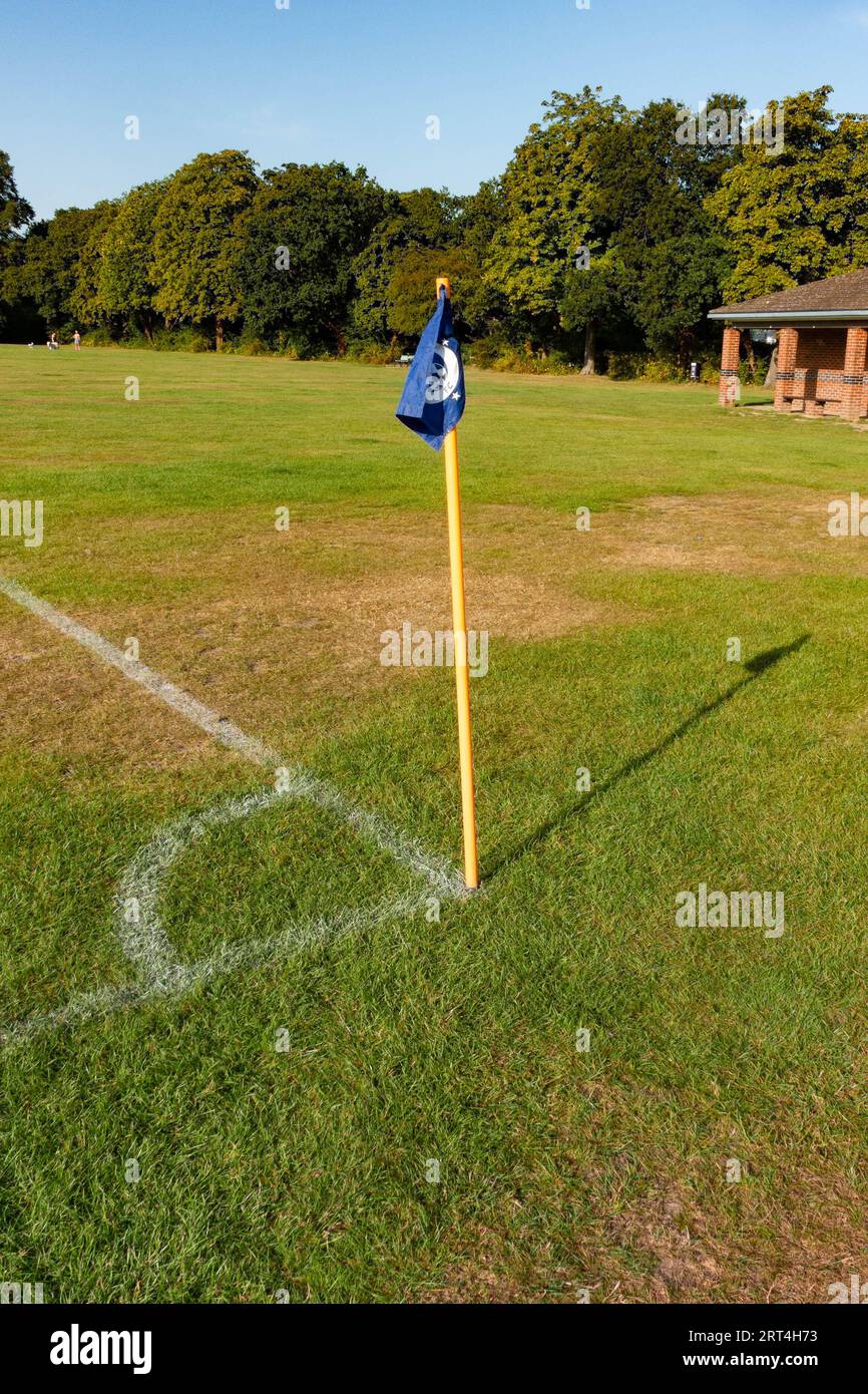 A corner flag and pitch markings at the corner of a football or soccer