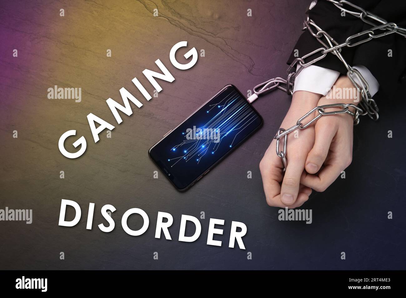 Photo inspiration: A Gaming Disorder Reference: Gaming Disorder Man Showing Chained Hands To Smartphone At Table