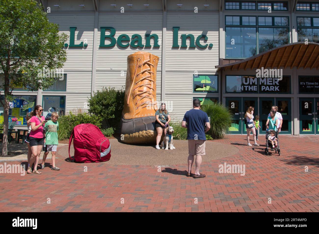 Tourists and shoppers pose with the duck boot outside of the LL Bean Retail Store, Freeport, Maine, USA Stock Photo